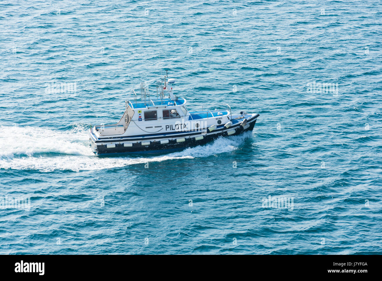 Abstract and conceptual help. A pilot boat in sea. A pilot boat is a