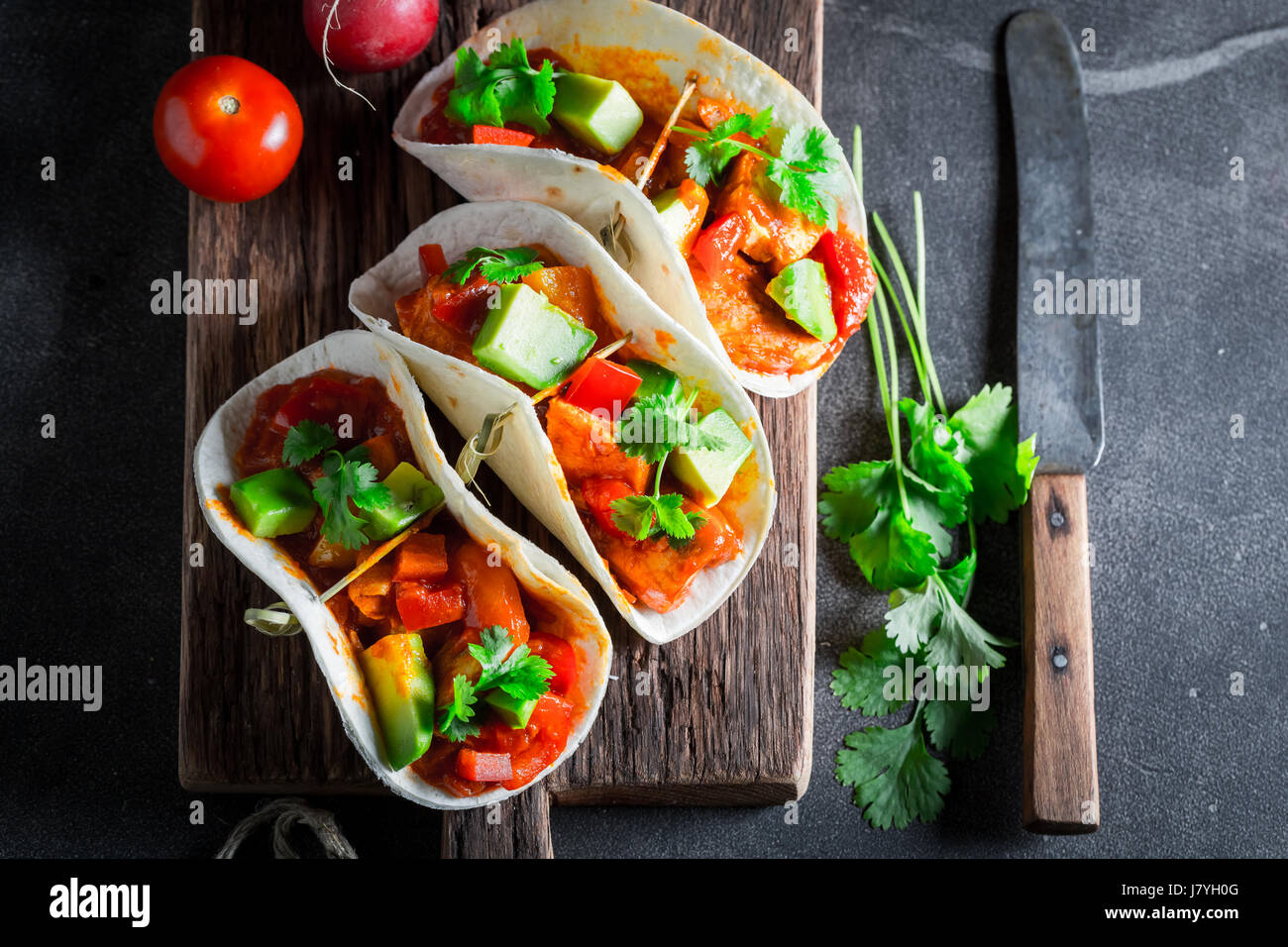 Spicy tacos with avocado, lime and tomato sauce Stock Photo