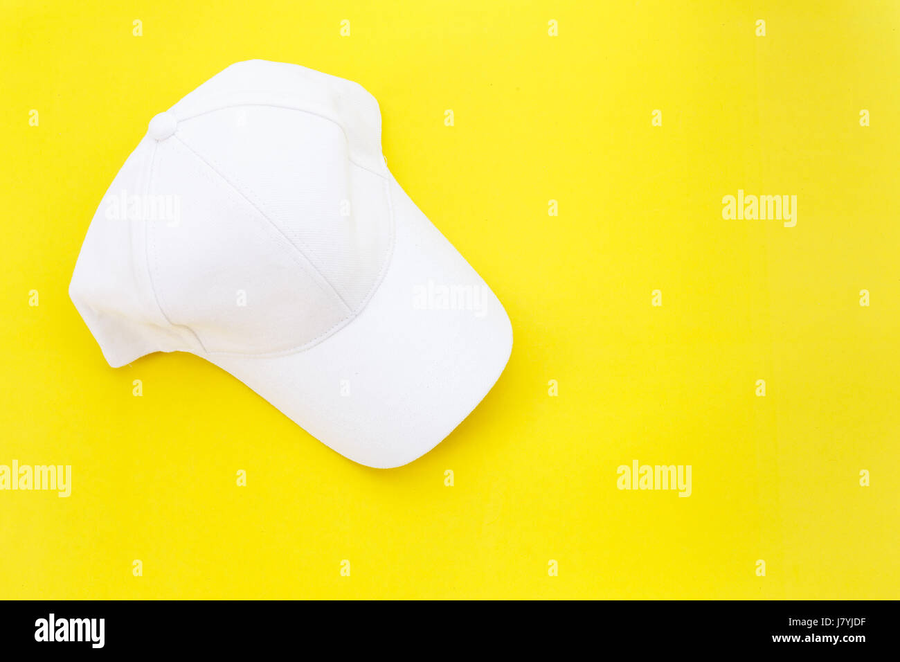 Top view new blank white baseball hat on yellow background with free