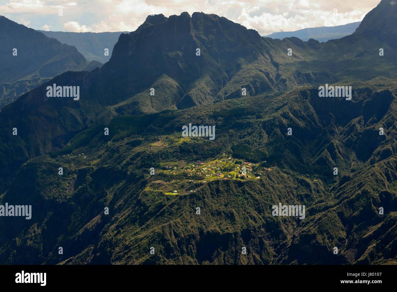 Small village La Nouvelle, view from the rempart Le Maïdo, peak of Morne de Fourche at back, Cirque de Mafate, Réunion Island, France, Indian Ocean Stock Photo