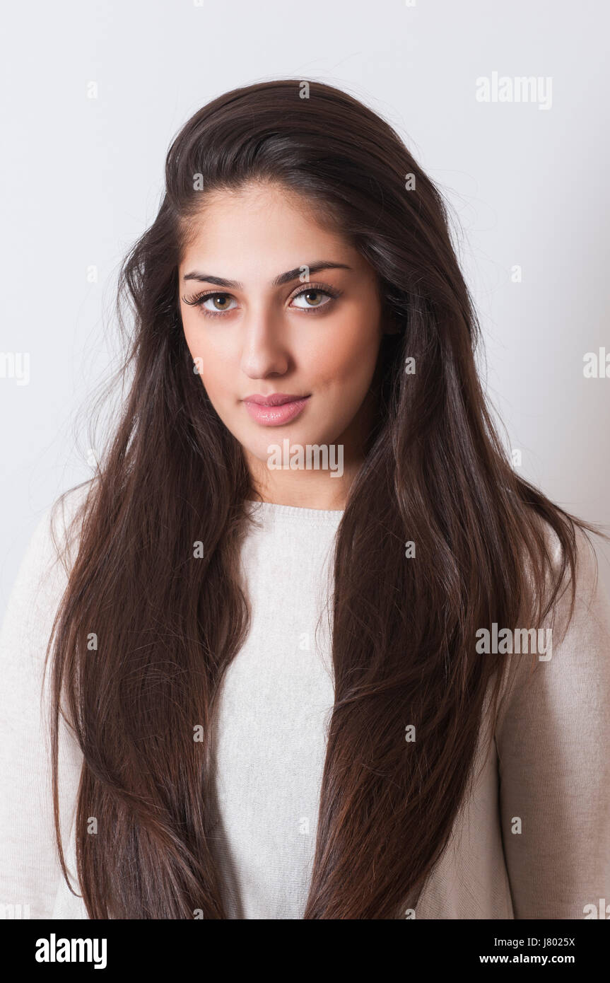 Beautiful young Indian woman with long dark hair smiling Stock Photo ...