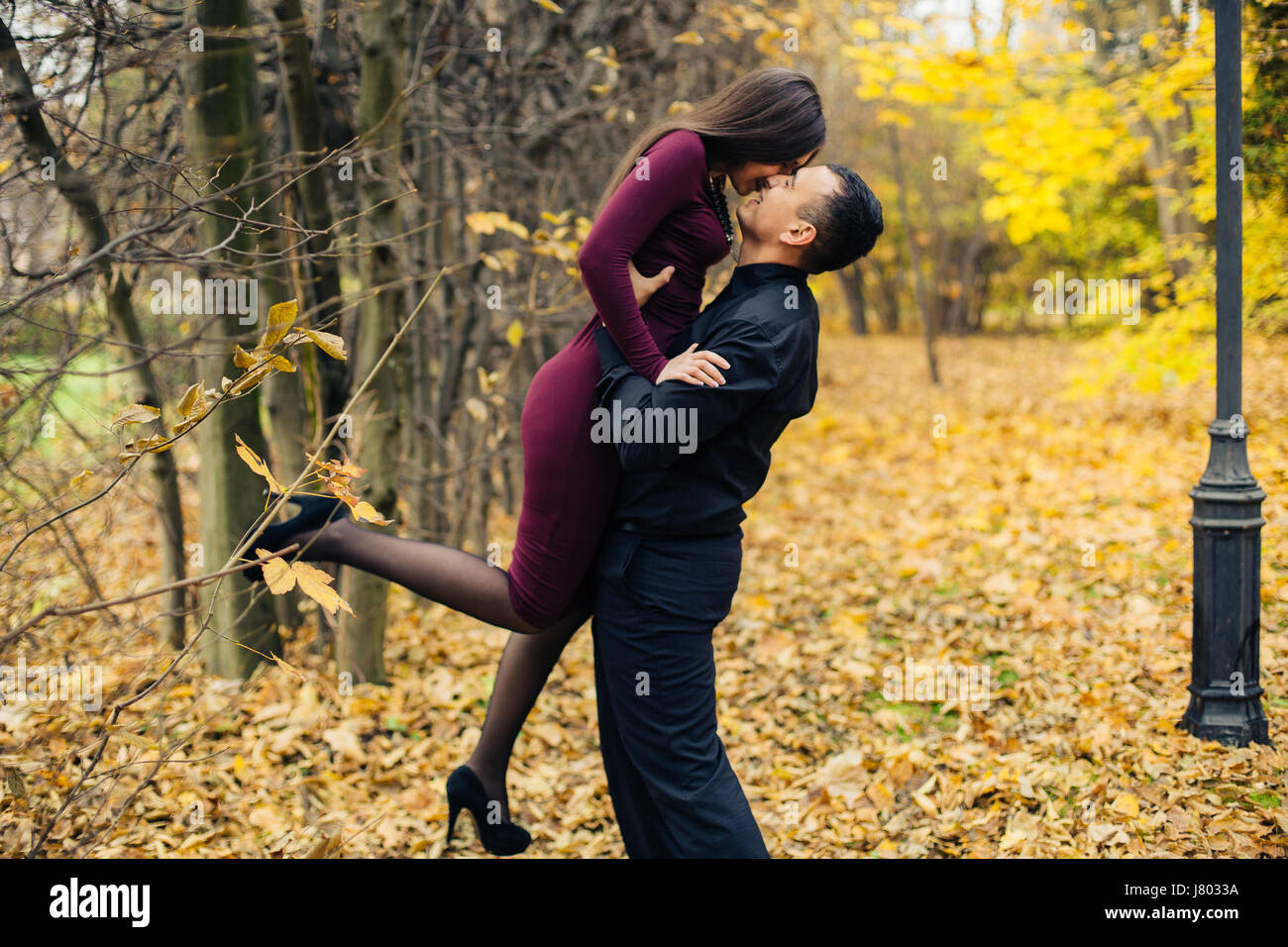 portrait of happy couple posing in park Stock Photo - Alamy