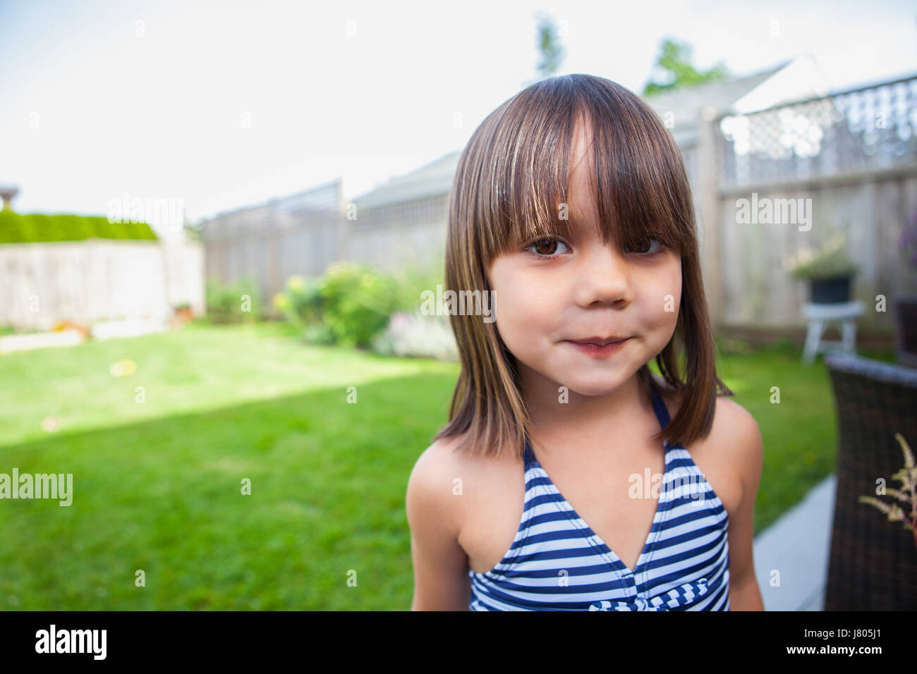 Portrait girl in bathing suit in summer backyard Stock Photo