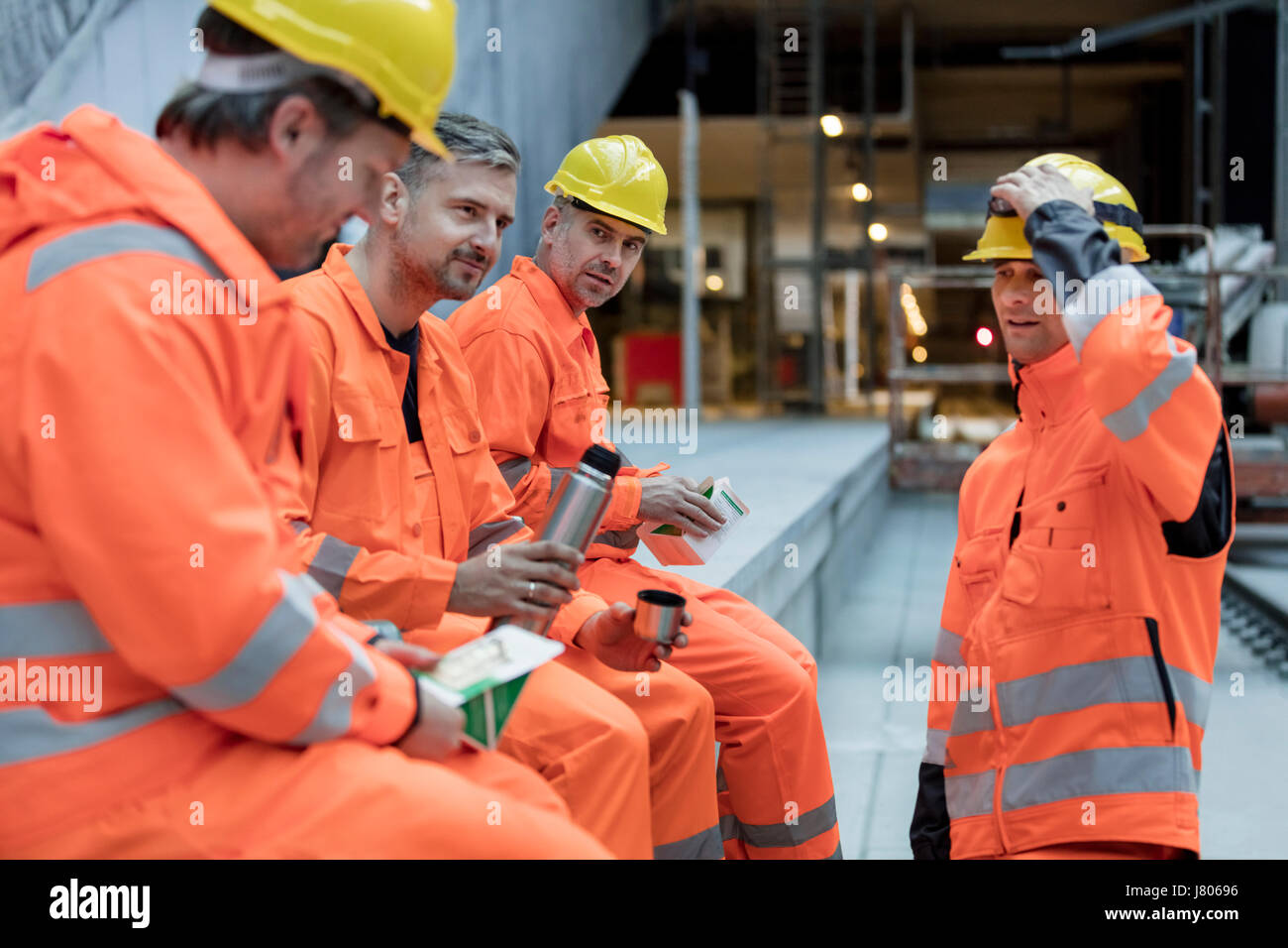 Construction workers eating lunch at construction site Stock Photo - Alamy