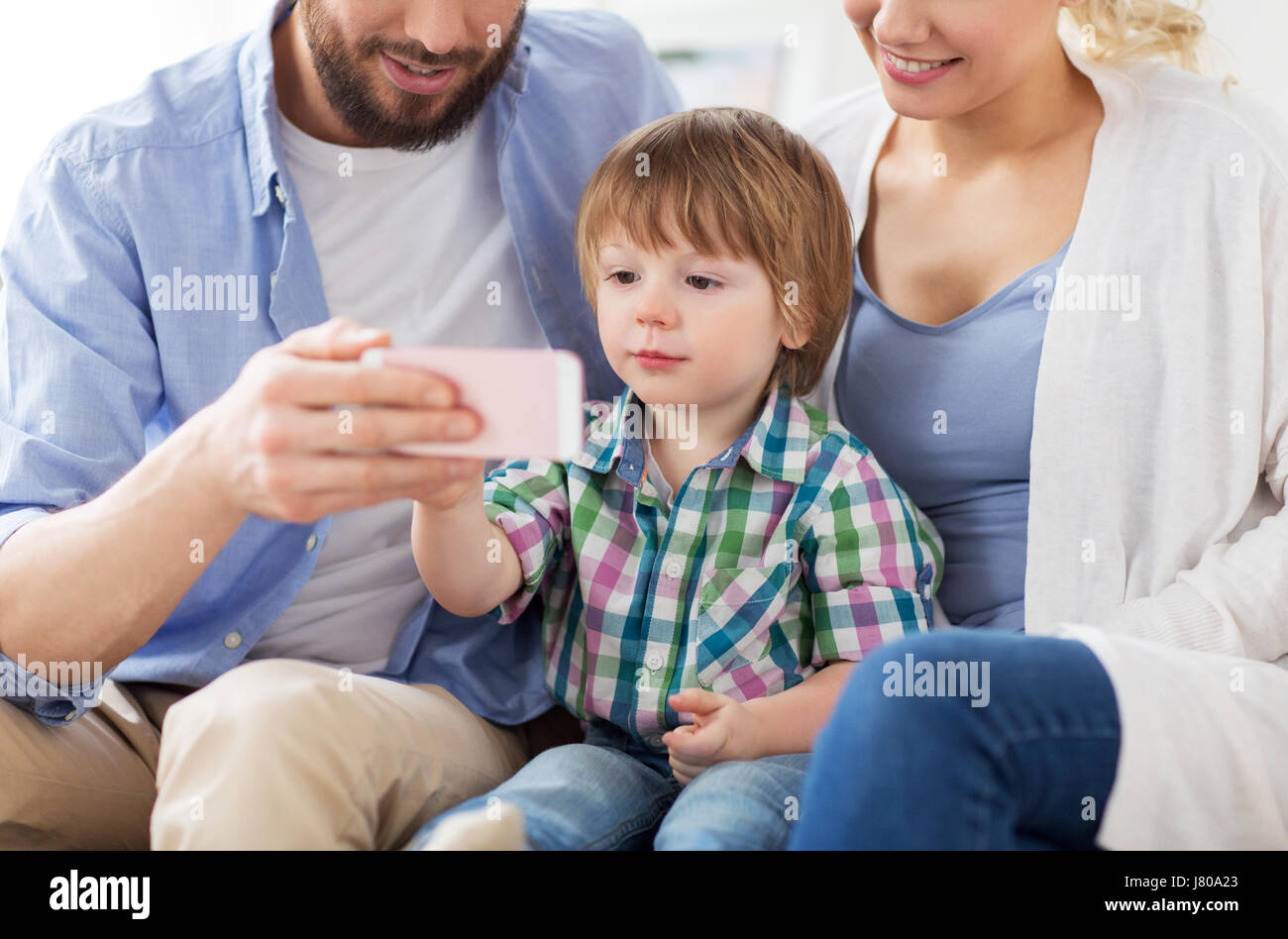 happy family with smartphone at home Stock Photo - Alamy