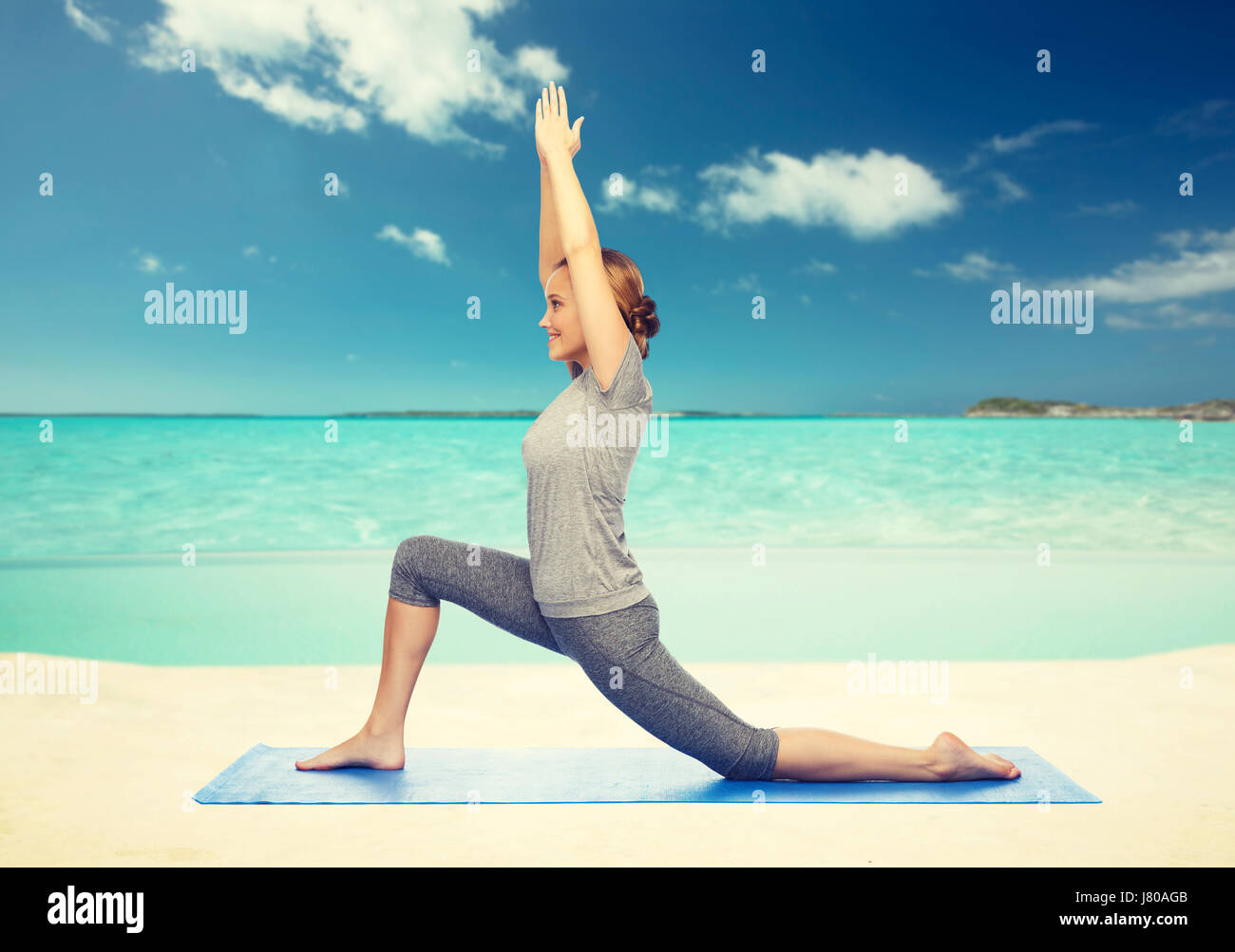 happy woman making yoga in low lunge on mat Stock Photo - Alamy