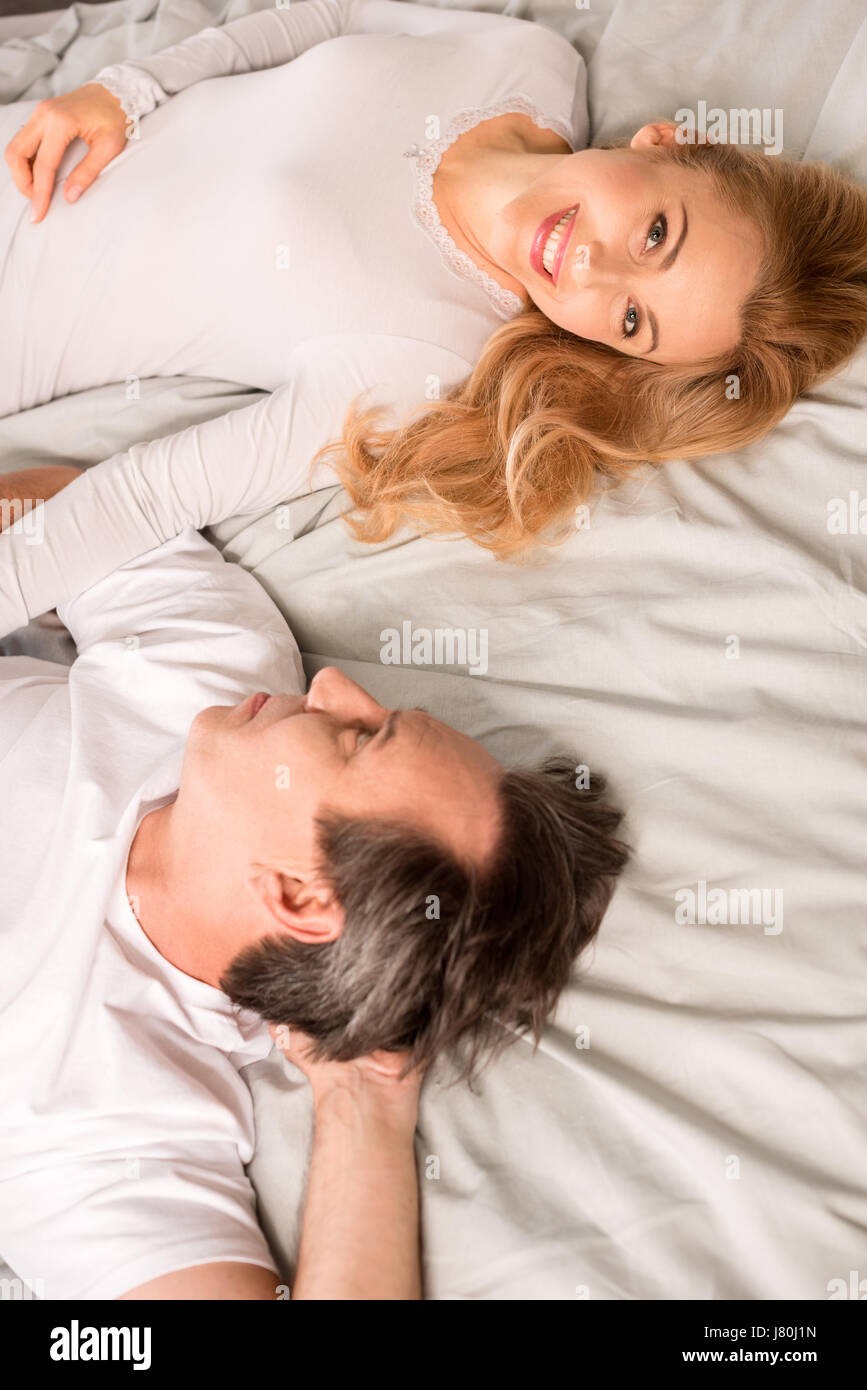 Top view of beautiful happy mature couple lying in bed Stock Photo - Alamy