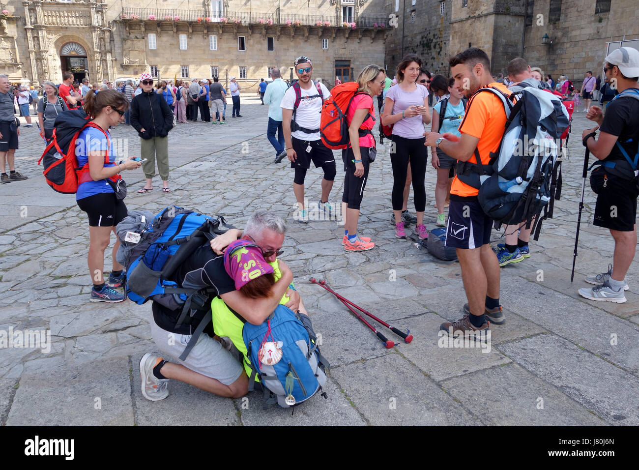 The moment of emotion as Pilgrims arrive in the Cathedral Square of Santiago de Compostela in northern Spain after walking the  Camino de Santiago Stock Photo