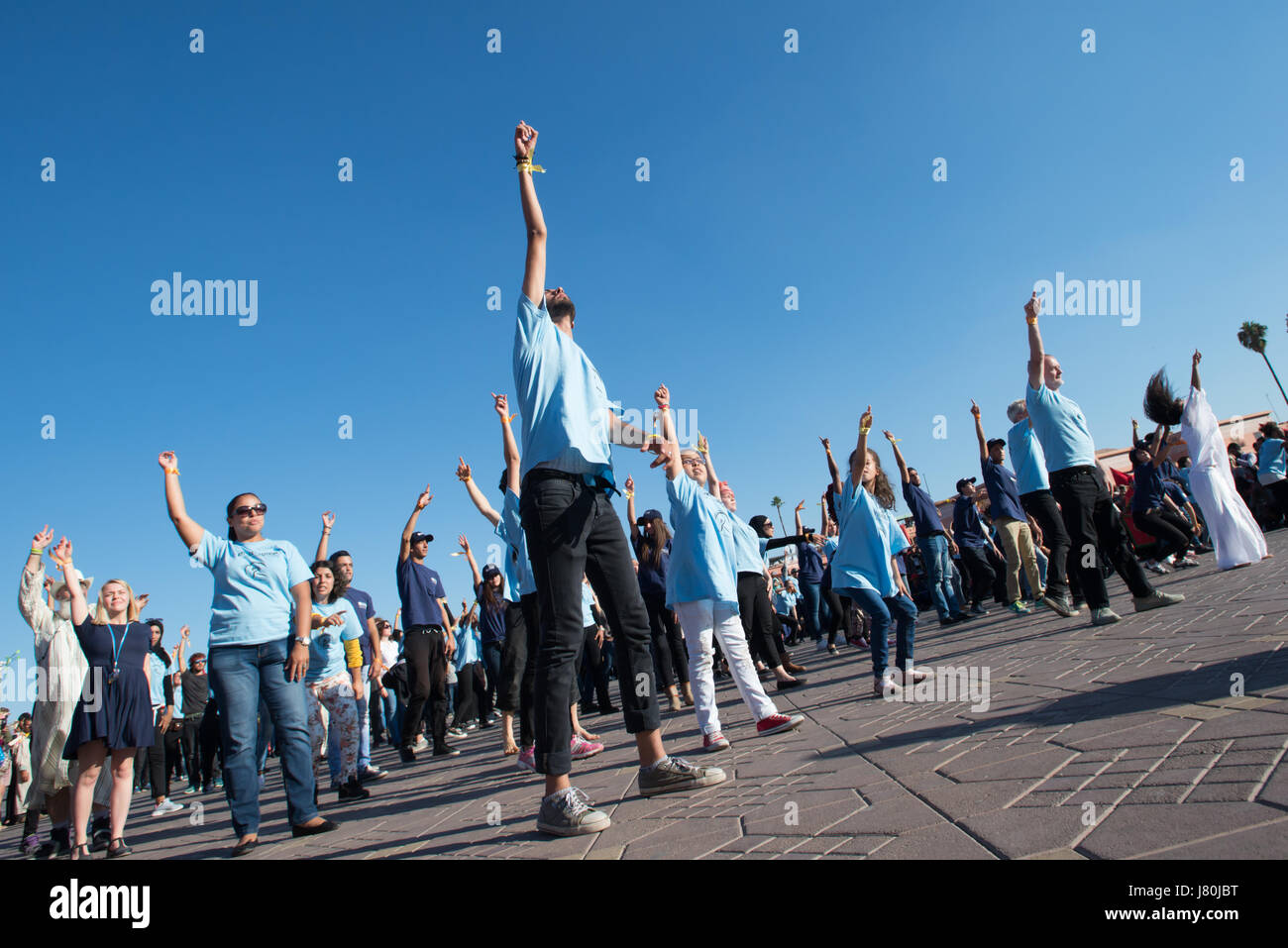 Young activists at the COP22 UN climate conference take part in a flashmob dance protest in Jemaa el-Fnaa, the central market plaza in Marrakech, Morocco, November 10, 2016. Stock Photo