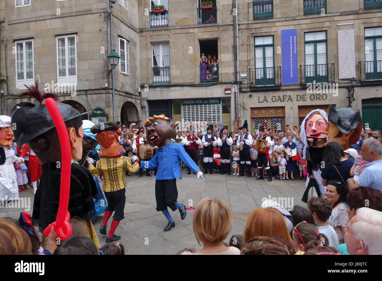 Gigantes y cabezudos giant figures parade through the streets of Santiago de Compostela in northern Spain during the Ascension day festival. Stock Photo