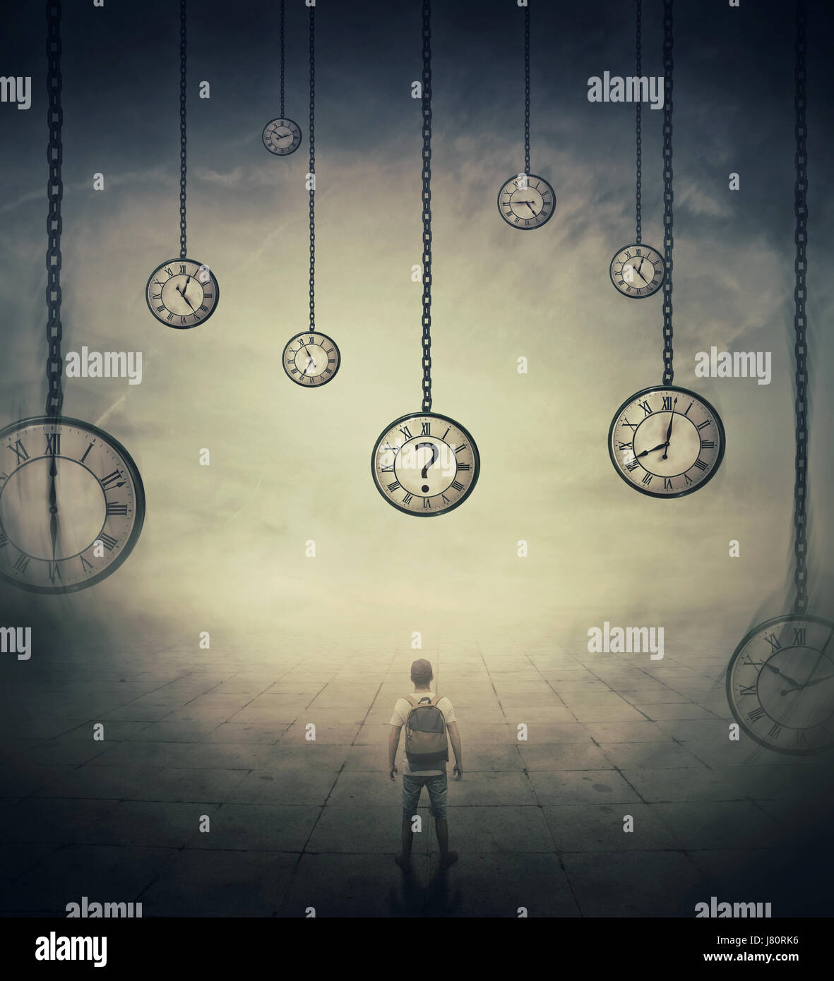 Surrealistic image with a man lost in time, standing in a foggy street in front of huge clocks set to different times. Hour perception and time travel Stock Photo
