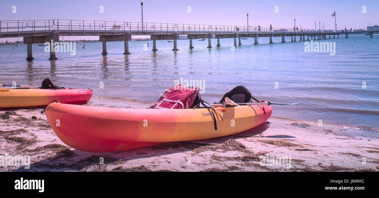 Kayaks pulled up onto a beach in Gulfport, Florida Stock Photo