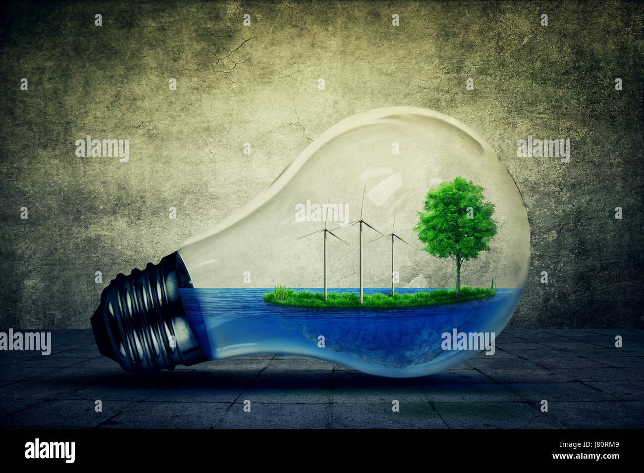 Light bulb as a micro planet with blue water and a island with green grass and tree growing inside. Windmill generator as the symbol of energy conserv Stock Photo