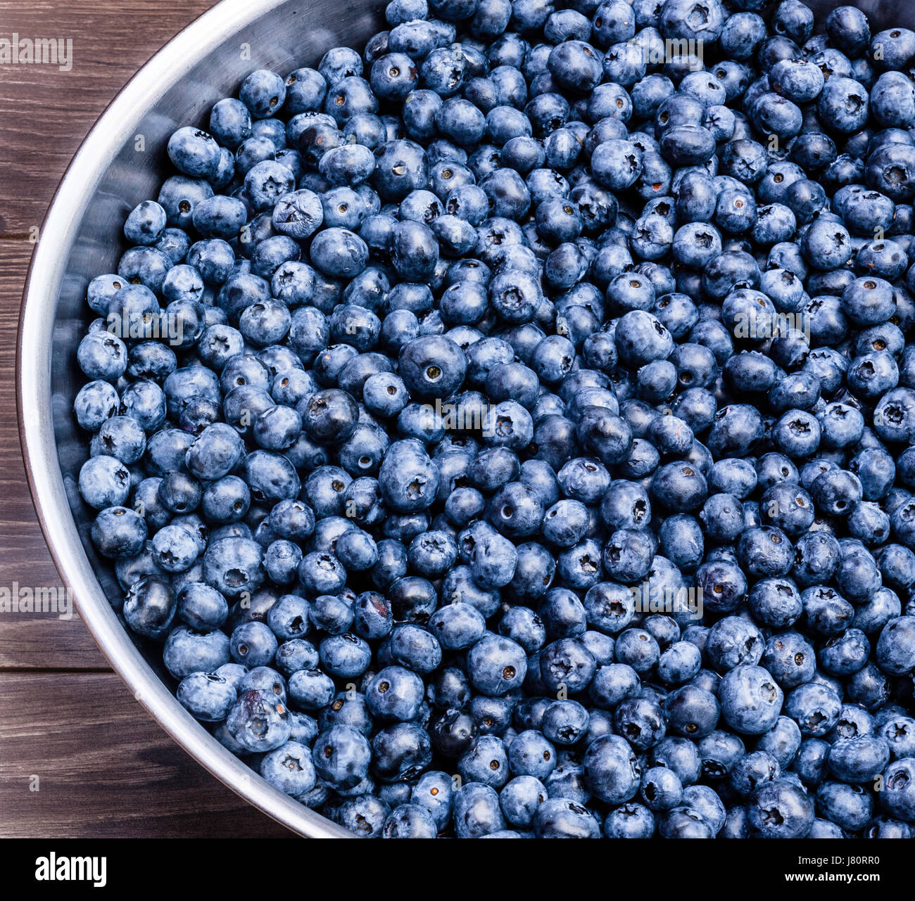 Fresh wild blueberries in a stainless steel bowl Stock Photo