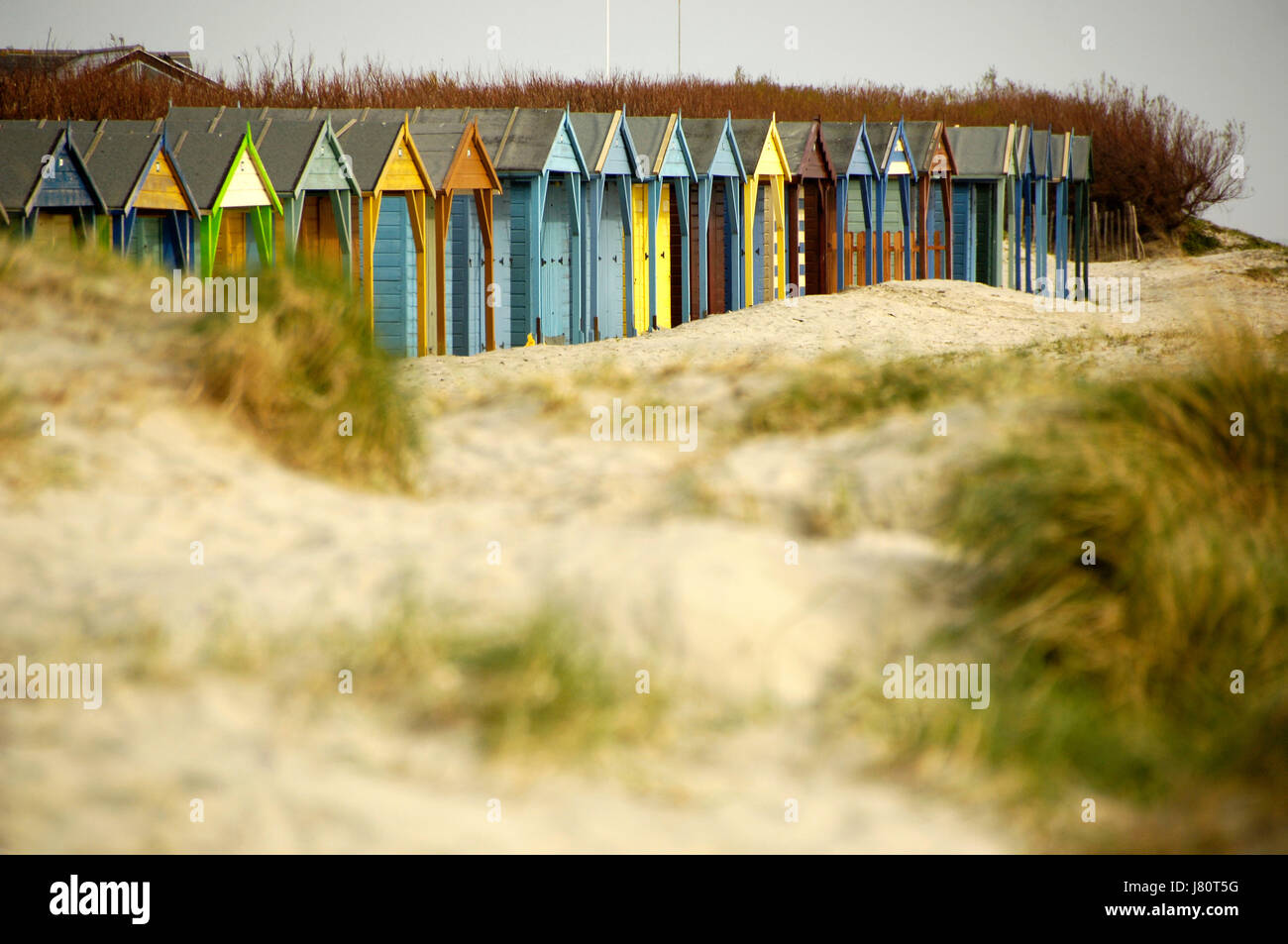 Colourful beach huts on a pebble beach. South Coast of England Stock