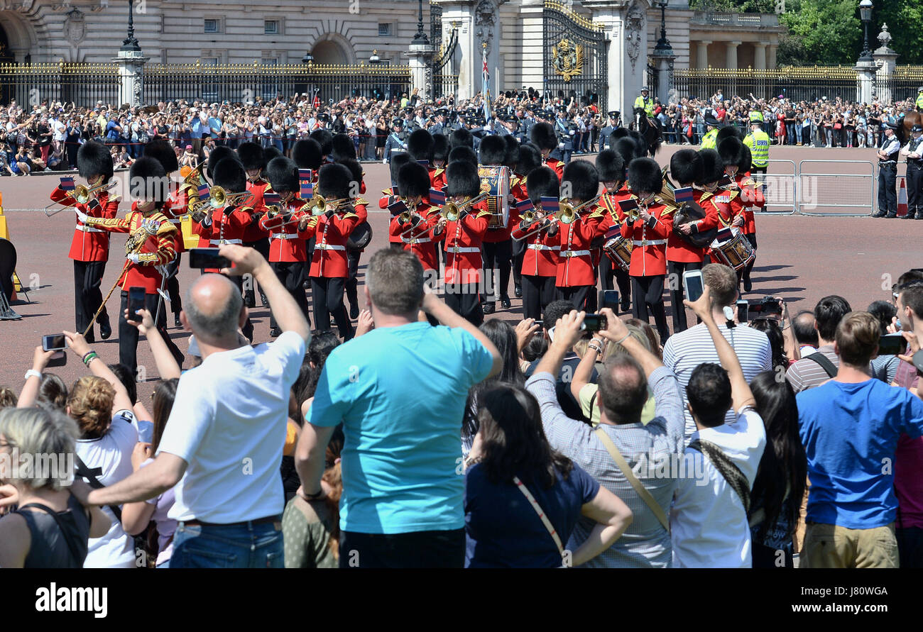 Tourists watch the Changing the Guard ceremony outside Buckingham