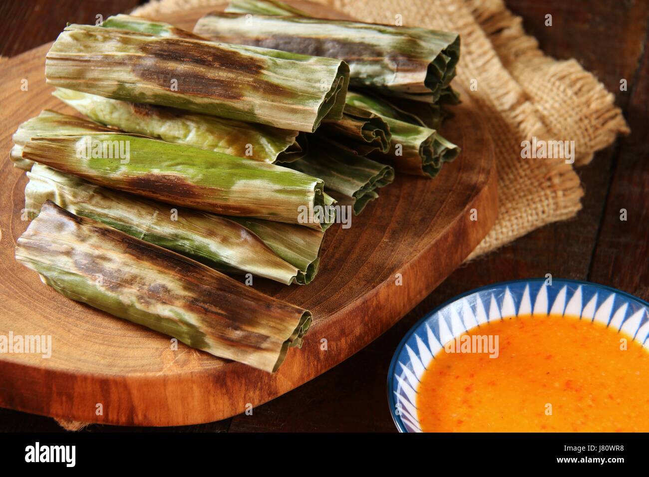 Otak-otak, Indonesian fish cake wrapped in banana leaf. A popular snack in Jakarta. Stock Photo