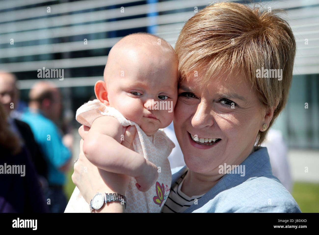 SNP leader Nicola Sturgeon holds 9-month-old Aurora Francotte Devine after making an election campaign visit to Scottish Gas HQ in Granton, Edinburgh. Stock Photo