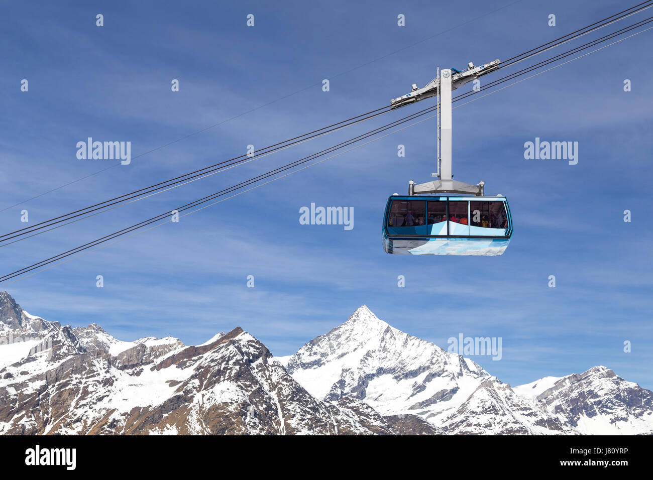 Zermatt, Switzerland - April 12, 2017: A cable car in the Swiss Alps on it's way to the mountain top Stock Photo