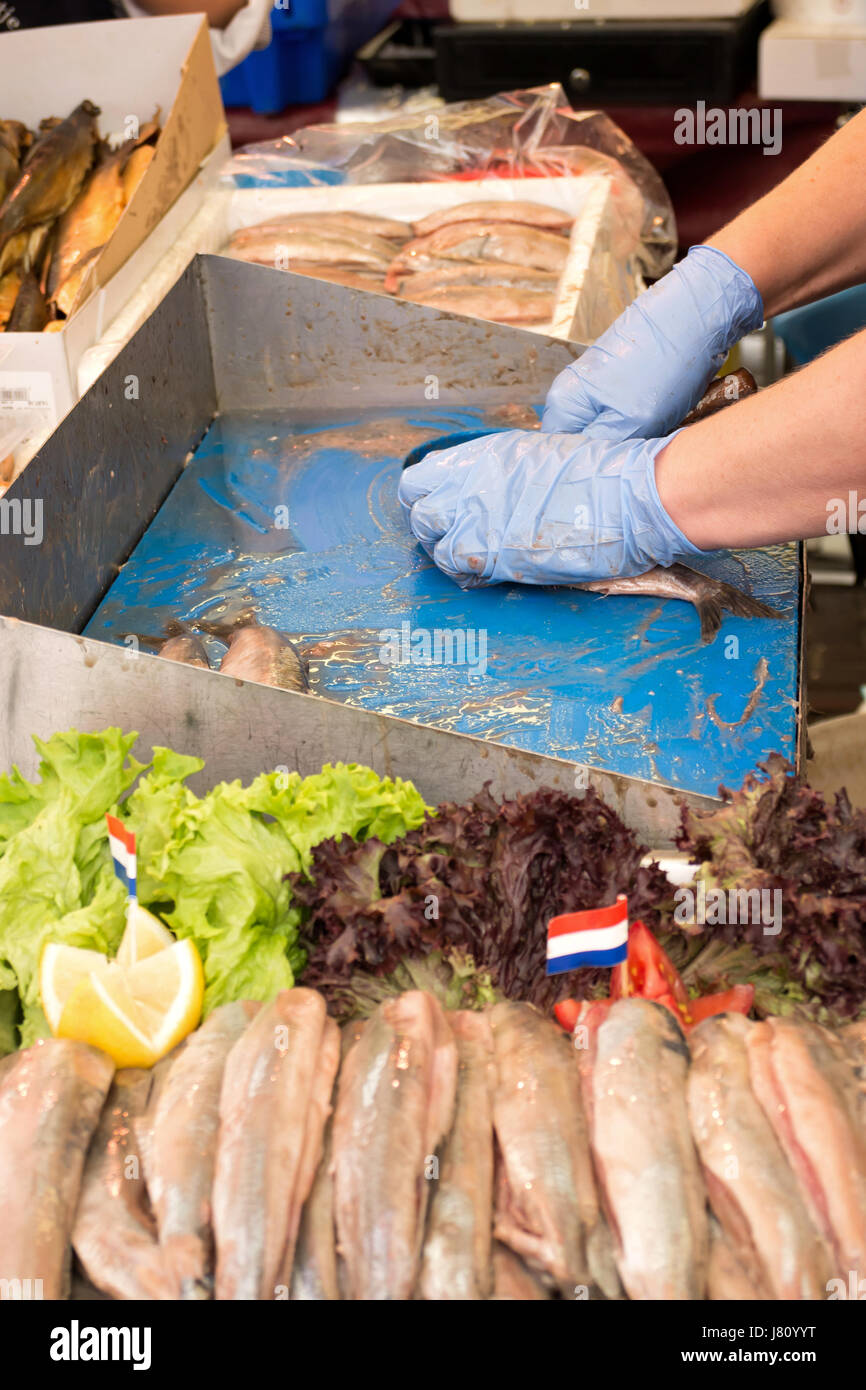 traditional soused herring being prepared and offered at Dutch weekly market Stock Photo