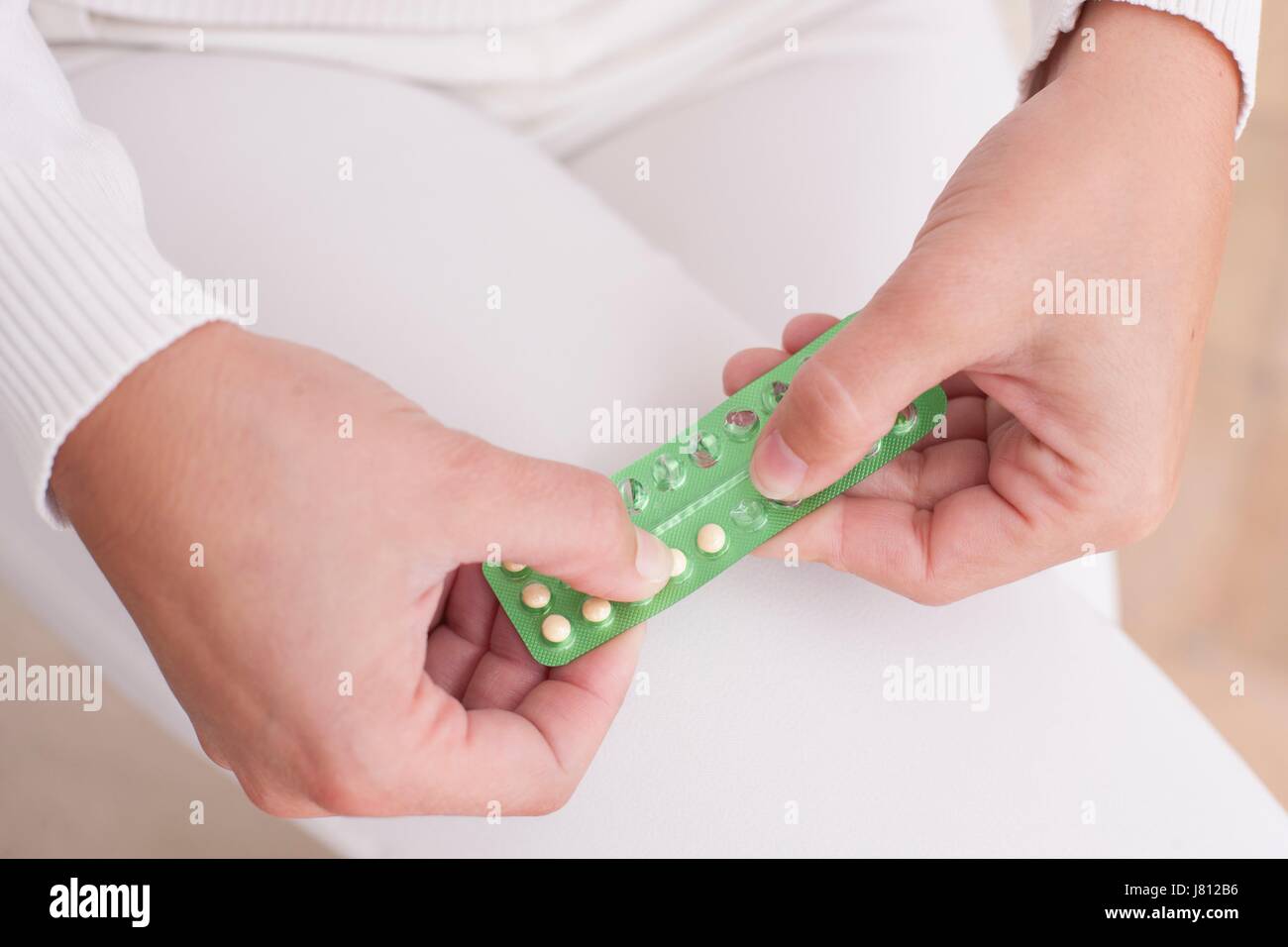 Woman holding blister pack with contraceptive pills. Stock Photo