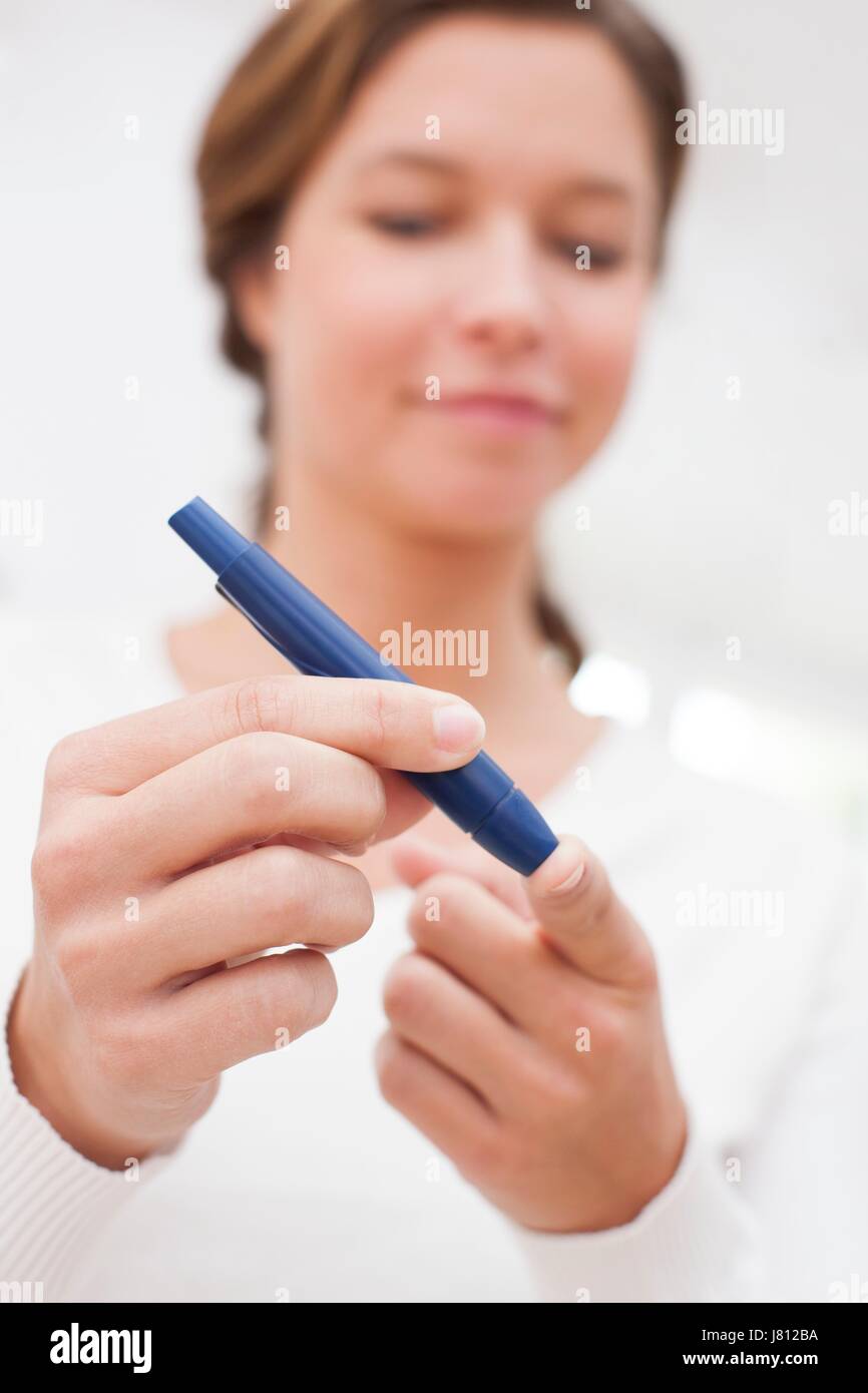 Woman doing finger prick test for blood glucose Stock Photo Alamy