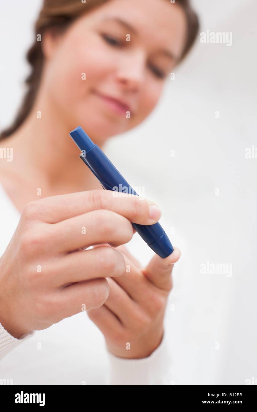 Woman doing finger prick test for blood glucose Stock Photo Alamy