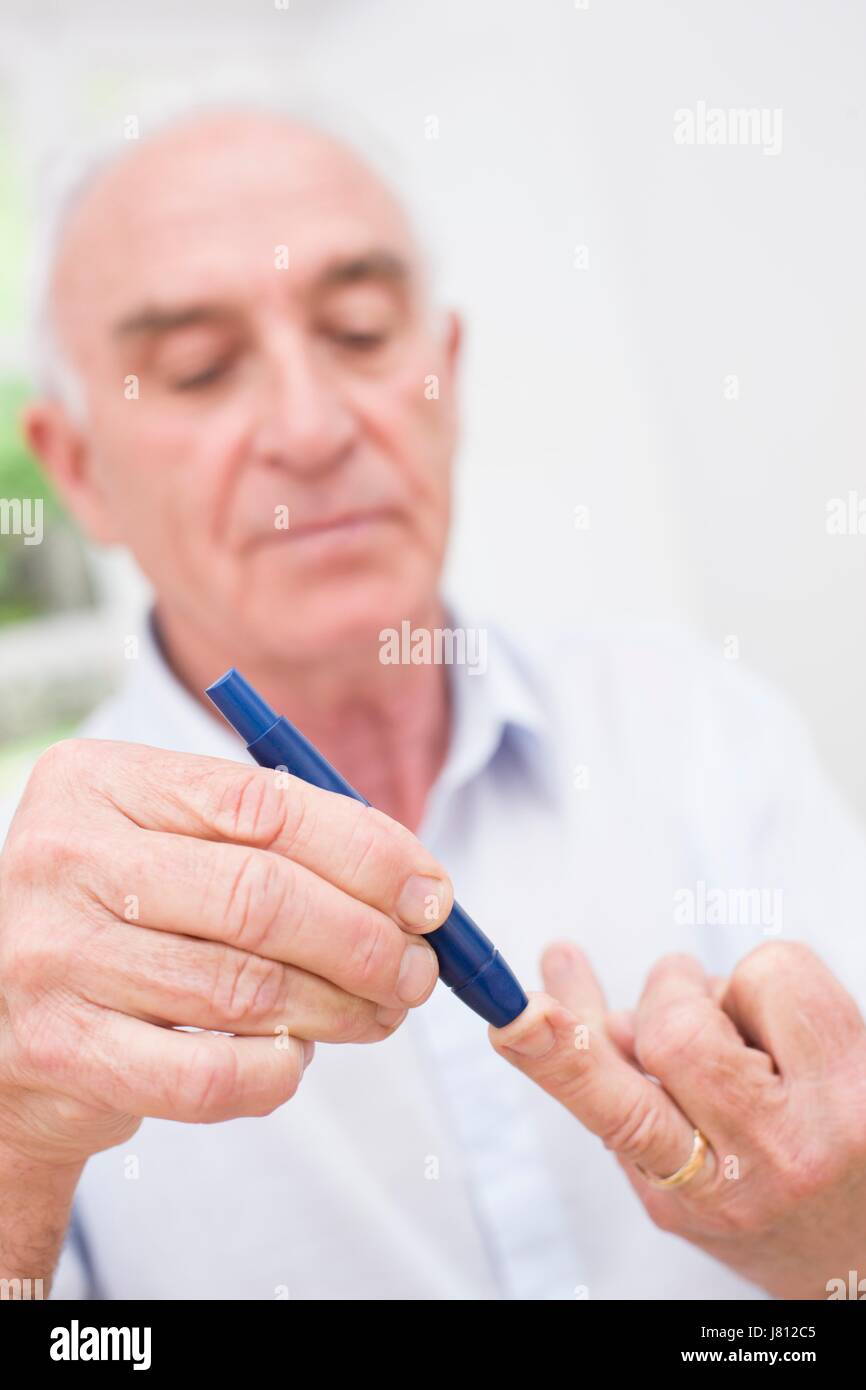 Man doing finger prick test for blood glucose Stock Photo Alamy