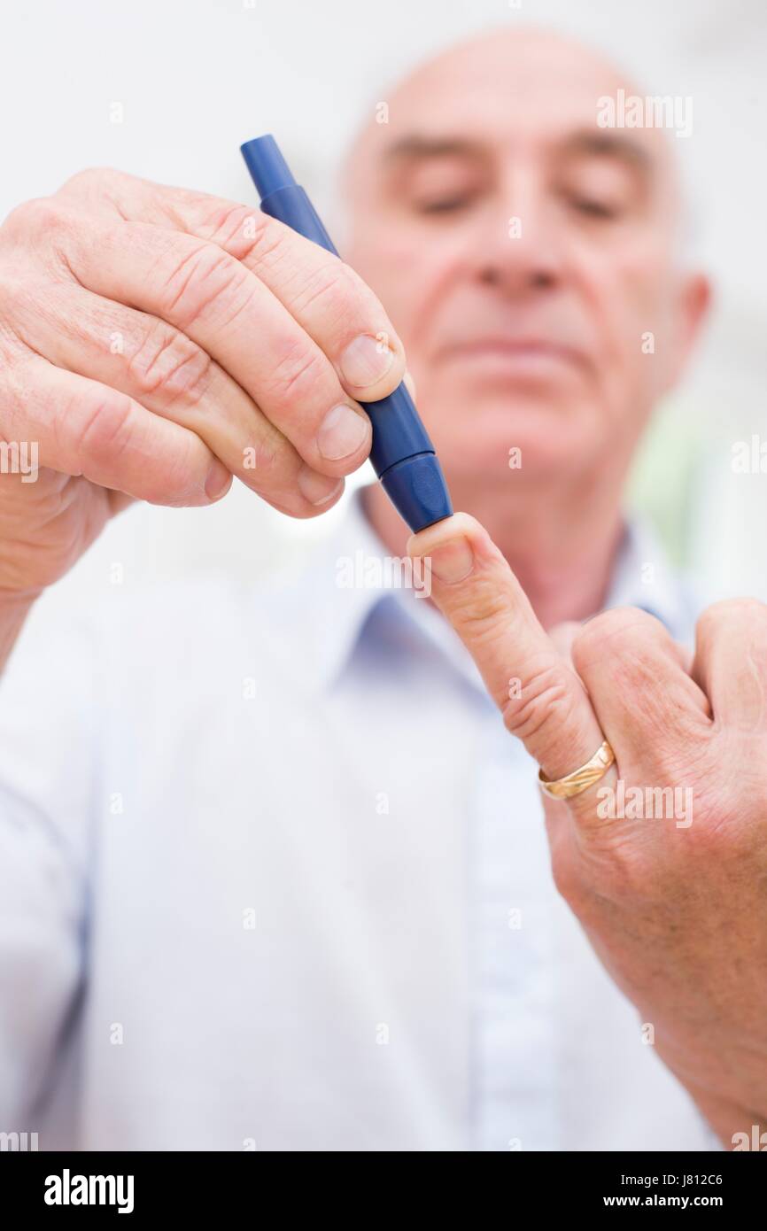 Man doing finger prick test for blood glucose Stock Photo Alamy