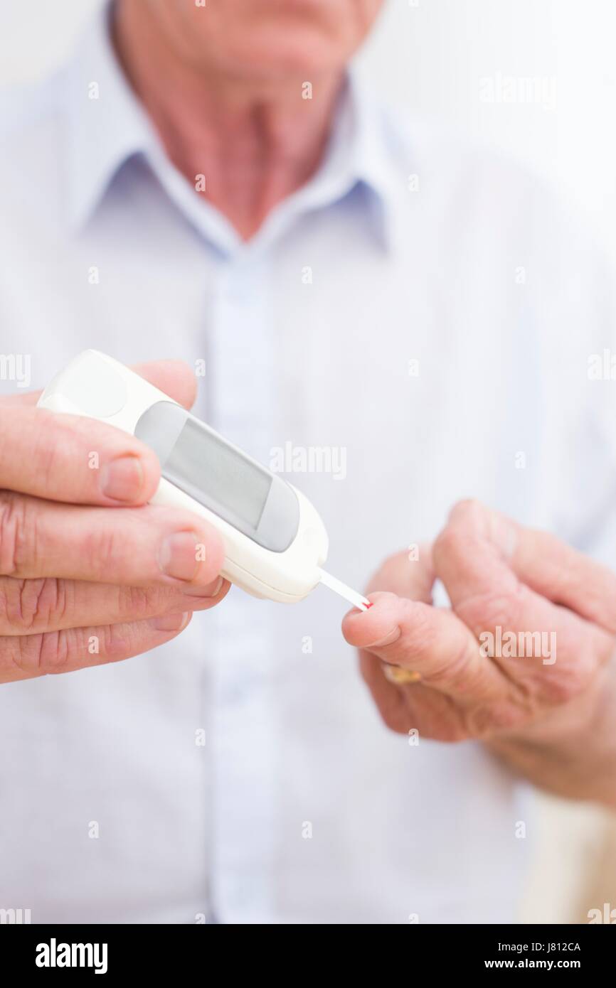 Man doing finger prick test for blood glucose Stock Photo Alamy