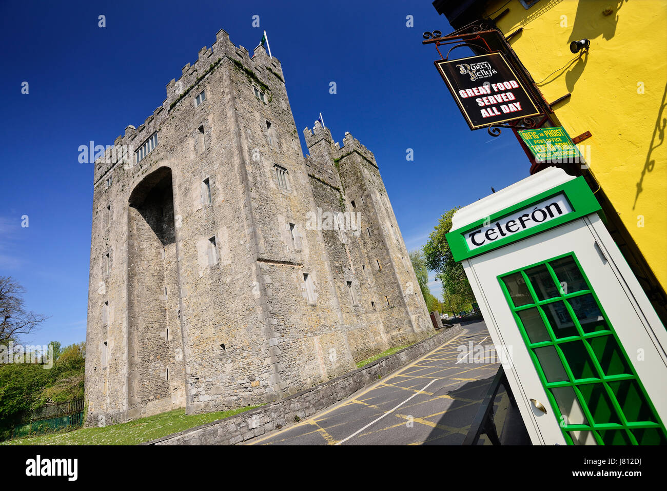 Ireland, County Clare, Bunratty Castle with traditional Irish telephone box nearby. Stock Photo