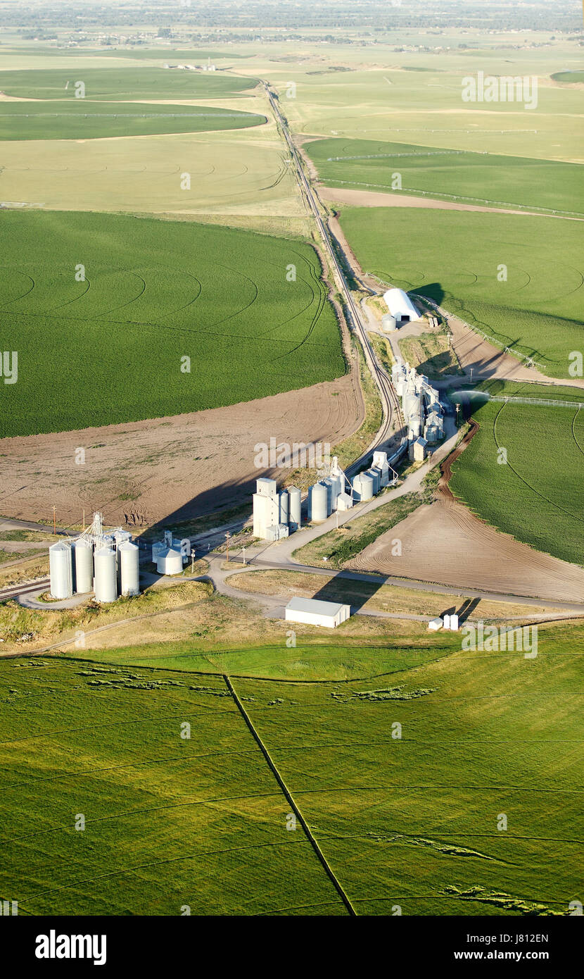 An aerial view of farmland and farm buildings with fields in the background. Stock Photo