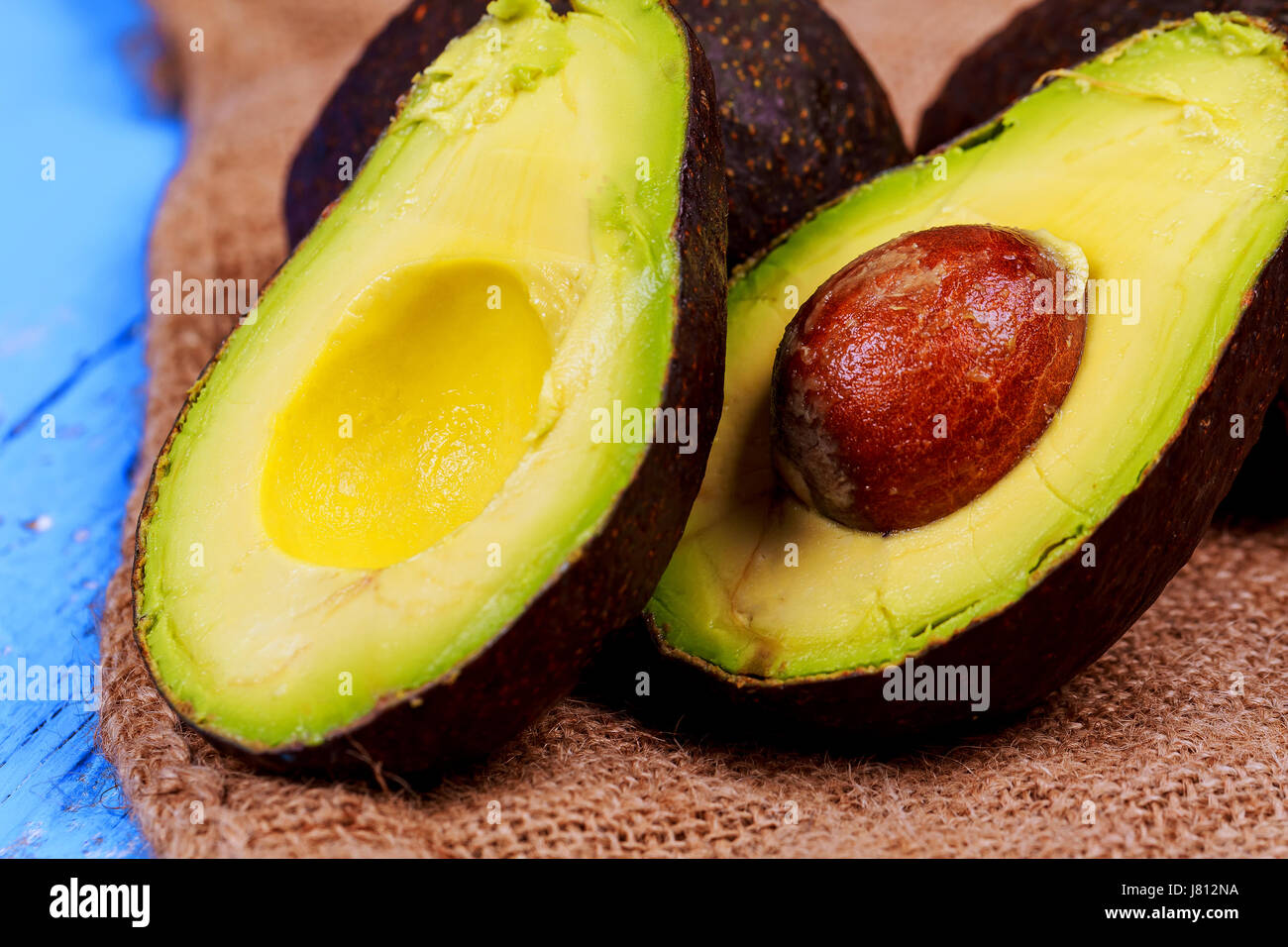 Fresh avocado on cutting board over wooden background Stock Photo - Alamy