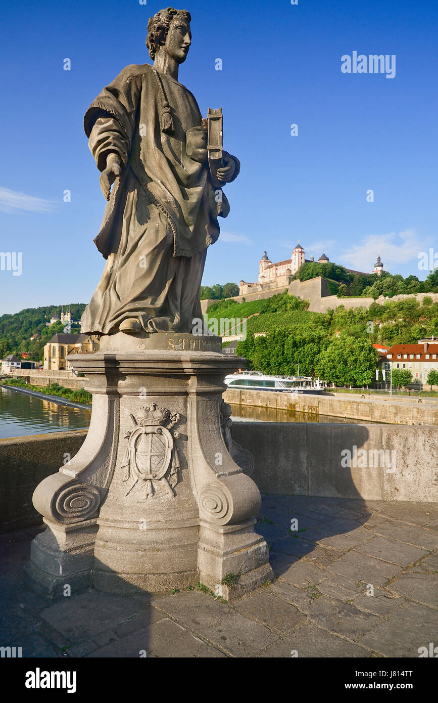 Germany, Bavaria, Wurzburg, Festung Marienberg above the River Main with a statue of St Totnan on Alte Mainbrucke. Stock Photo