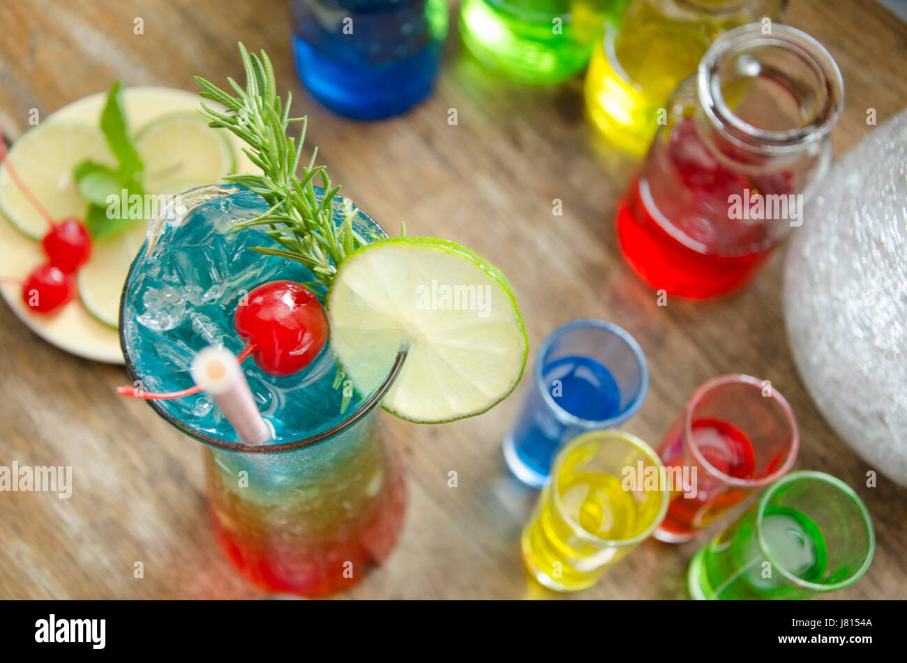 Colorful Glass of rainbow fruit juice and ingredients on the wood table. Stock Photo