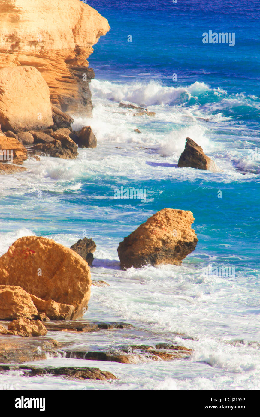 Seashore Waves and Mountain under the Sunshine in Matrouh, Egypt / View of Beautiful Seashore Waves and Majestic Mountain under the Sunshine in Matrou Stock Photo