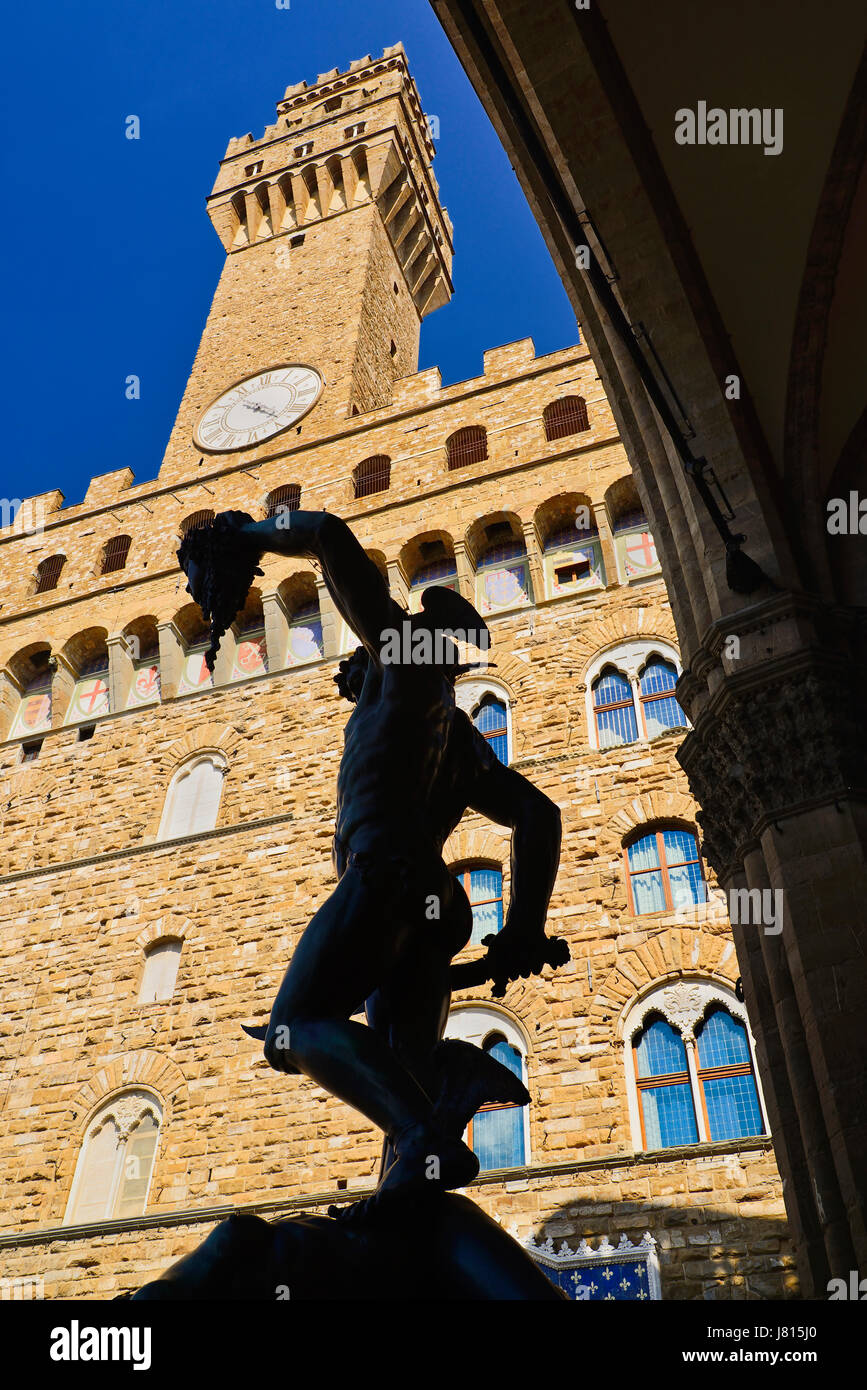 Italy, Tuscany, Florence, Piazza della Signoria, Palazzo Vecchio with the Perseus statue silhouetted. Stock Photo