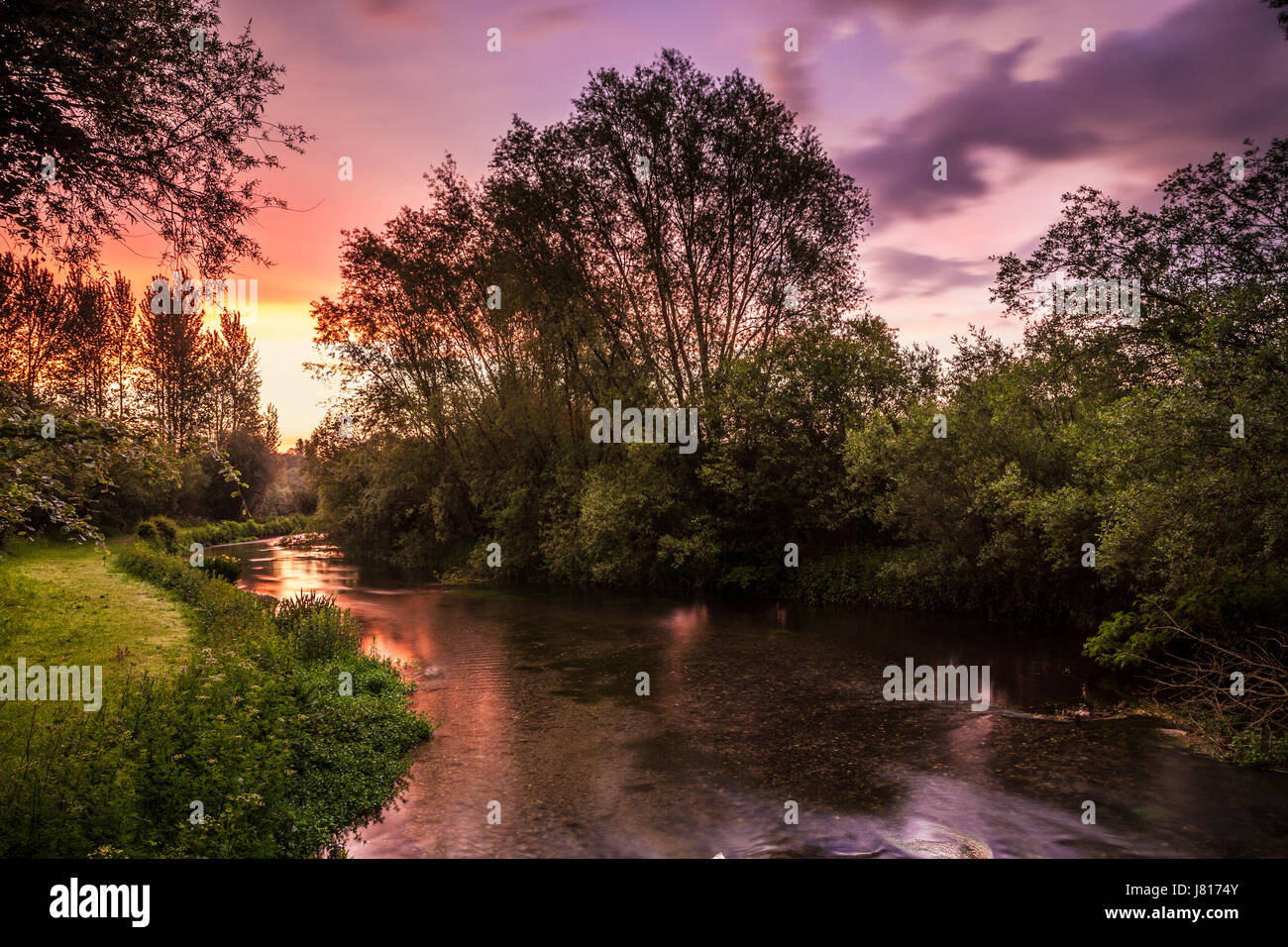 A colourful and dramatic sunrise over the River Kennet in Wiltshire. Stock Photo