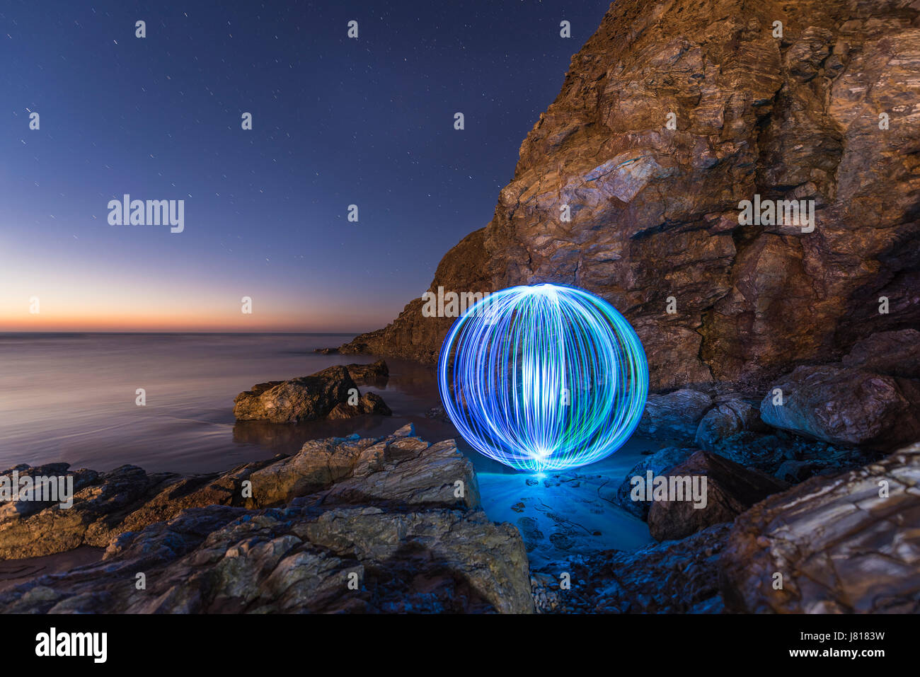 Light Painting Orb in a Cave Perranporth Beach, United Kingdom Stock