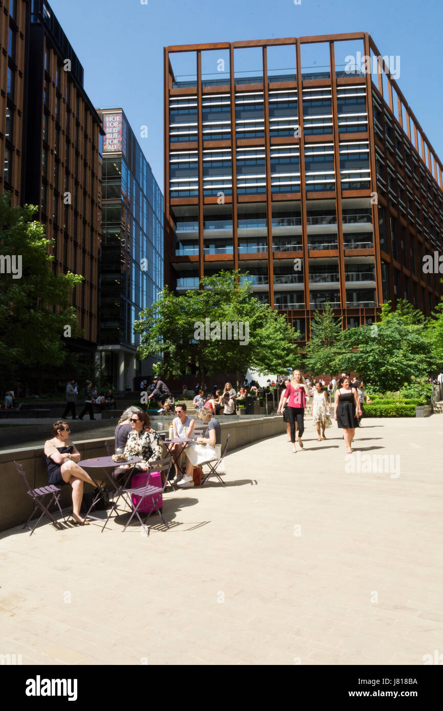 Office workers relaxing in Pancras Square near Google HQ in King's Cross, London, England, UK Stock Photo
