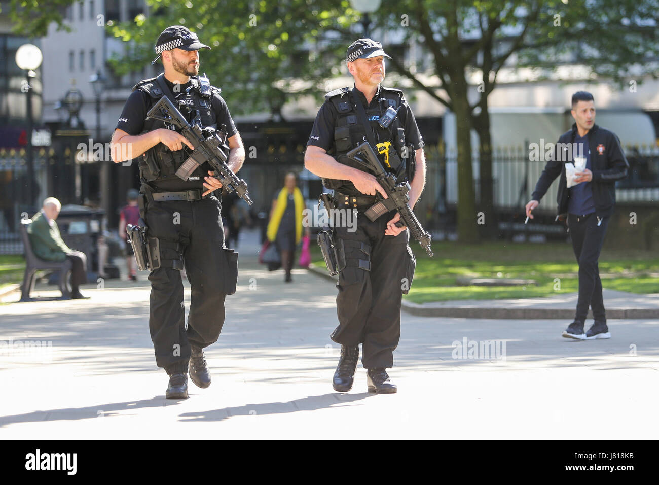 Armed UK police officers units patrolling city Britain Stock Photo