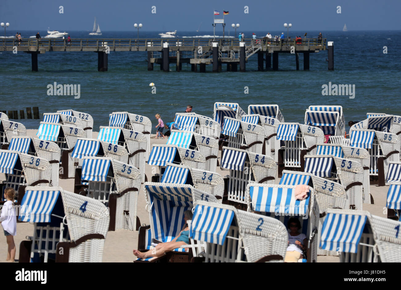 Wicker beach chairs can be seen at the beach in Kuehlungsborn, Germany, 26 May 2017. The last weekend of May will see copious amounts of sunshine and high temperatures. Photo: Bernd Wüstneck/dpa-Zentralbild/dpa Stock Photo