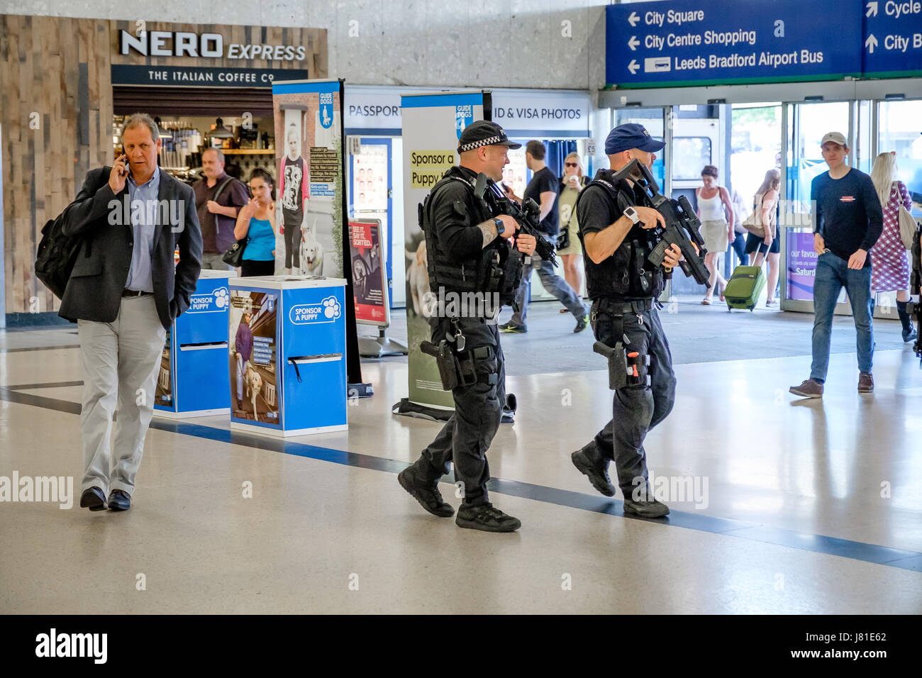 Armed Police patrol Leeds City Railway Station. West Yorkshire. UK. 26 May 2017. In the wake of the terrorist attack in Manchester, armed officers from the UK's Civil Nuclear Constabulary (CNC) have been deployed to support local armed police in the north of England. The usual role of the CNC is to provide armed policing and security for UK civil nuclear establishments. Here CNC officers are seen patrolling with officers of the West Yorkshire Police Firearms Support Unit at Leeds City train station. Credit: Ian Wray/Alamy Live News Stock Photo