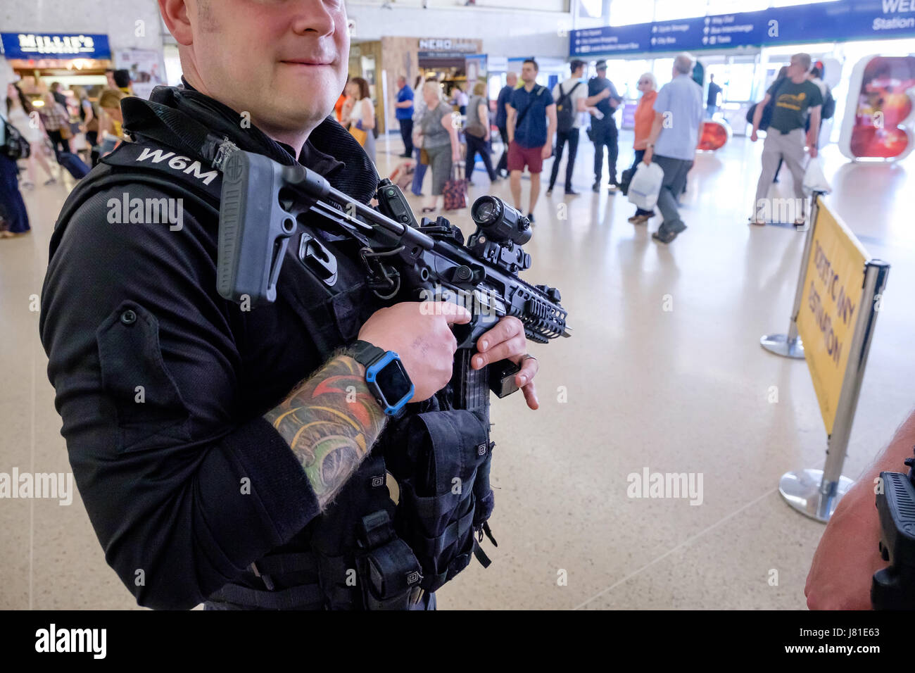 Armed Police patrol Leeds City Railway Station. West Yorkshire. UK. 26 May 2017. In the wake of the terrorist attack in Manchester, armed officers from the UK's Civil Nuclear Constabulary (CNC) have been deployed to support local armed police in the north of England. The usual role of the CNC is to provide armed policing and security for UK civil nuclear establishments. Here CNC officers are seen patrolling with officers of the West Yorkshire Police Firearms Support Unit at Leeds City train station. Credit: Ian Wray/Alamy Live News Stock Photo