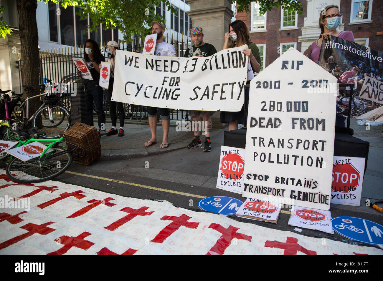 London, UK. 26th May, 2017. Cycle safety campaigners from Stop Killing Cyclists hold a vigil and die-in outside the headquarters of the Conservative Party to mark the deaths of an estimated 280,000 people from largely transport-related air pollution since 2010. Campaigners were calling for a commitment to increase investment in clean-air protected cycling infrastructure to 10% of the transport budget by 2020. Credit: Mark Kerrison/Alamy Live News Stock Photo