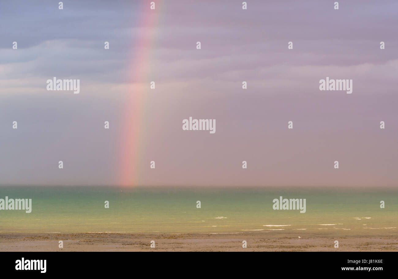 Rainbow and dark rain clouds over the sea Stock Photo - Alamy