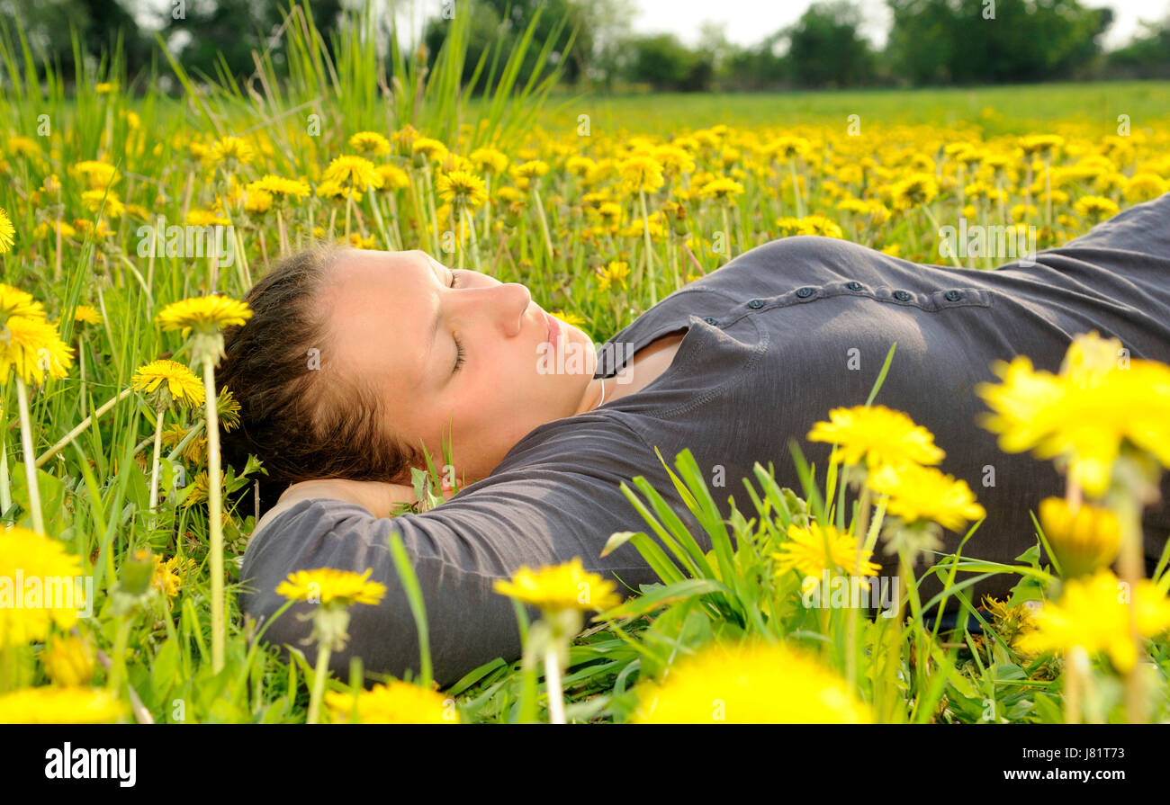 young woman lying on a flower meadow Stock Photo