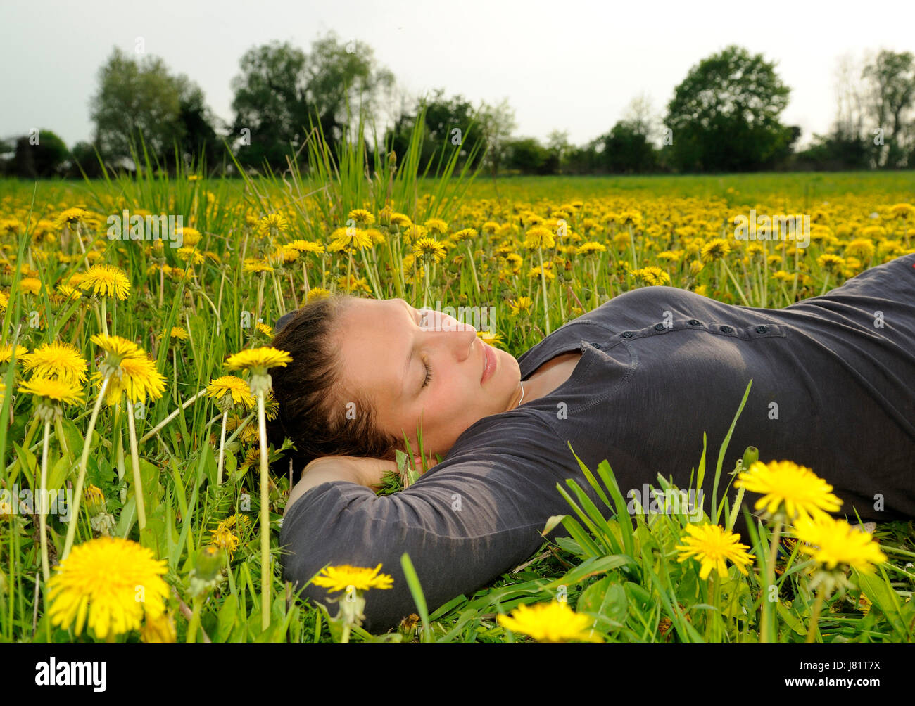 young woman lying on a flowery meadow Stock Photo