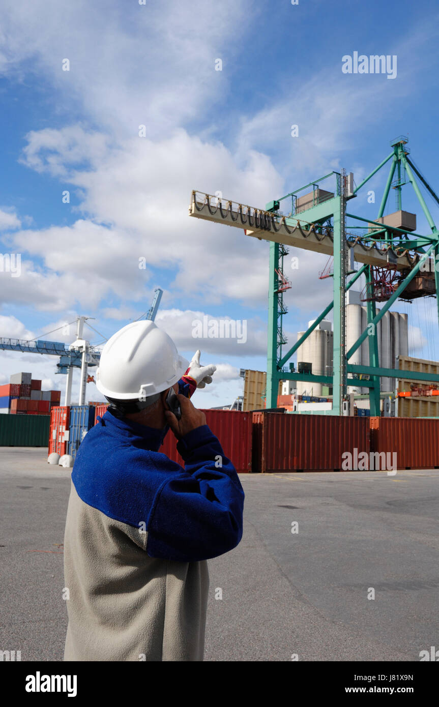 transport dock container port cargo shipping workers laborer worker wageworker Stock Photo