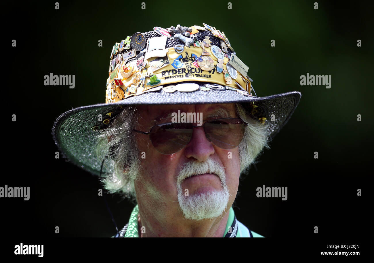 Golf themed pin badges on his hat 